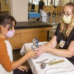 Nurse testing patients hand grip strength